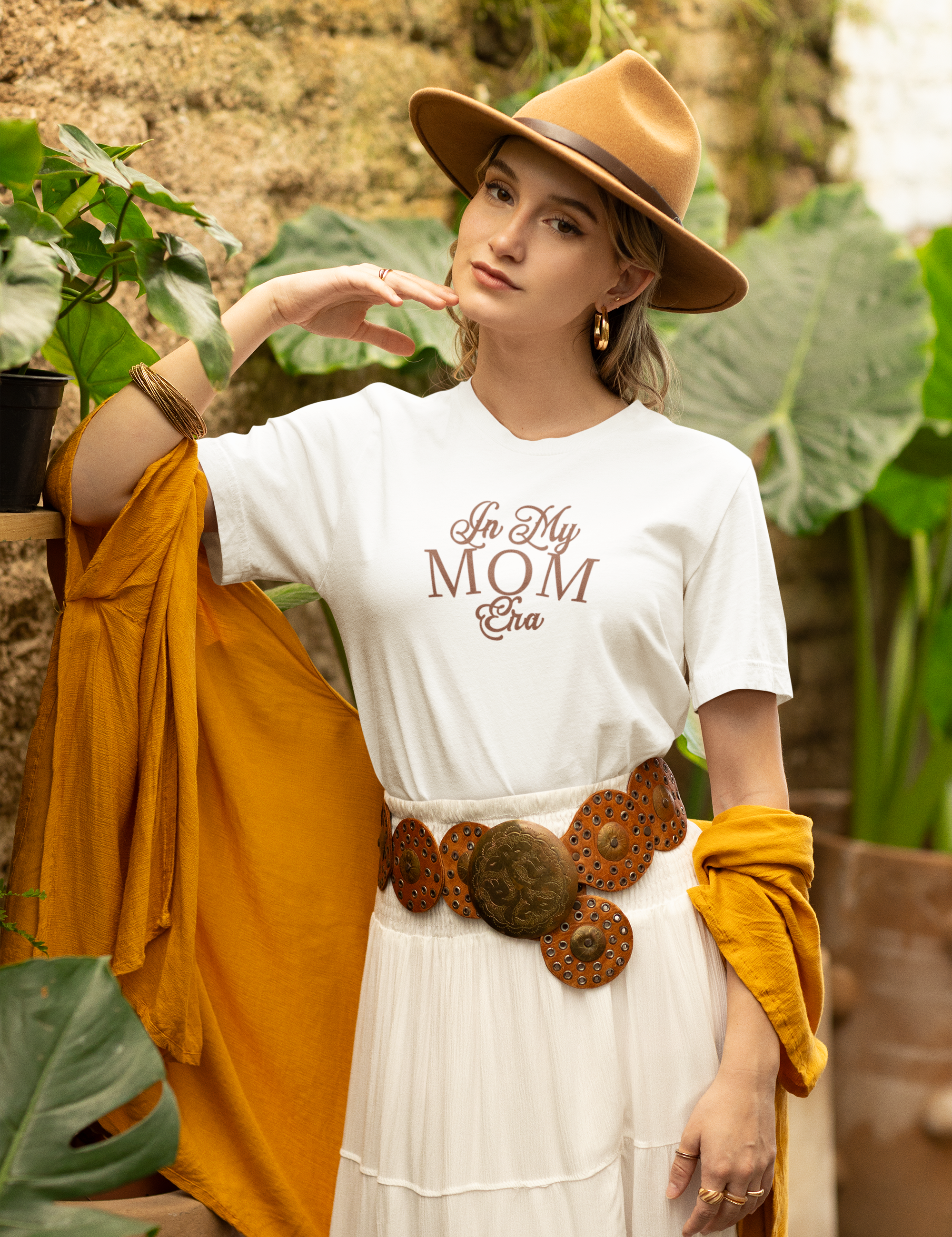 bella-canvas-t-shirt-mockup-of-a-woman-in-a-boho-inspired-outfit-posing-by-some-plants-m36848.png